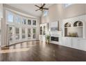 Spacious living room with a fireplace, built-in shelves, and large windows for natural light at 5975 Deerwoods Trl, Alpharetta, GA 30005