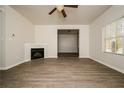 Bright living room featuring a corner fireplace and neutral decor at 604 Beaujolais Ct, Mcdonough, GA 30253