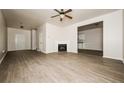 Spacious living room with fireplace and wood-look floors at 604 Beaujolais Ct, Mcdonough, GA 30253