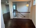 Upstairs hall with dark hardwood floors and a white railing staircase at 1957 Paxton Sw Dr, Lilburn, GA 30047