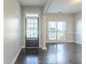 Light-filled foyer with hardwood floors and black front door at 129 Janney Cir, Mcdonough, GA 30253