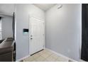 Bright entryway featuring neutral walls, tile flooring, and a modern security panel for added peace of mind at 1450 Riverrock Trl, Riverdale, GA 30296