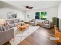 Bright and airy living room features modern furnishings, hardwood floors, and large windows at 30 N Cleveland Church Rd, Mcdonough, GA 30253