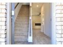 Inviting entryway with staircase and wood-look floors leading to a living space at 631 Egrets Lot 50 Lndg, Covington, GA 30014