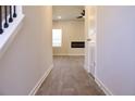 Hallway features durable wood-look floors, a fireplace view, and neutral paint at 631 Egrets Lot 50 Lndg, Covington, GA 30014