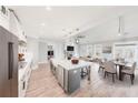 Open floor plan with a kitchen island, breakfast table, fireplace, and living area at 169 Alaina Rd, Holly Springs, GA 30115