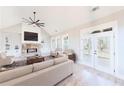 Bright living room features a fireplace, built-ins, and a ceiling fan at 169 Alaina Rd, Holly Springs, GA 30115
