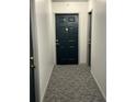 Inviting entry hall with dark-colored door and grey carpet at 1280 W Peachtree Nw St # 1013, Atlanta, GA 30309