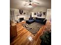Stylish living room featuring hardwood floors, a fireplace, and a modern area rug at 2961 Rolling Ln, Winston, GA 30187