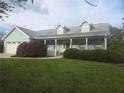 Charming one-story home with a welcoming front porch and well-manicured landscaping at 3825 Green Ave, Loganville, GA 30052
