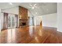 Spacious living room with hardwood floors, stone fireplace, and vaulted ceiling at 38 Timberlost Trl, Suwanee, GA 30024
