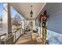 Inviting front porch with wooden flooring, white railings, and comfortable seating at 1670 Hosea L Williams Ne Dr, Atlanta, GA 30317