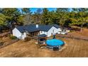This home features a backyard with a deck, patio, and an above ground pool at 3625 Pointer Rd, Loganville, GA 30052