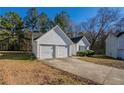 View of the two-car garage and driveway at 6959 Biscayne Blvd, Rex, GA 30273