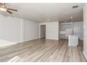 Open concept living room and kitchen with gray cabinets and vinyl flooring at 1347 Sunny Lake Dr, Lawrenceville, GA 30043
