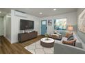 Bright living room with hardwood floors, a blue front door, and a comfortable seating area at 474 Fairlock Nw Ln, Atlanta, GA 30331