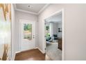 Open entryway with hardwood floors leading to a study through a doorway at 443 Village Ln, Fairburn, GA 30213