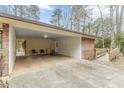 Covered carport with ample space, a ramp, and an adjacent storage area at 4485 Canary Ct, Lithia Springs, GA 30122