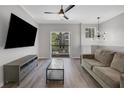 Bright living room with modern ceiling fan, decor light fixture, and sliding glass door to balcony at 1081 Liberty Pkwy, Atlanta, GA 30318