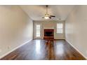 Spacious living room with hardwood floors, fireplace, and vaulted ceiling at 1624 Graystone Dr, Hampton, GA 30228