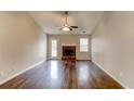 Spacious living room with hardwood floors, fireplace, and vaulted ceiling at 1624 Graystone Dr, Hampton, GA 30228