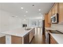 Open kitchen with island, stainless steel appliances, and hardwood floors at 615 Grassmeade Ln, Woodstock, GA 30188