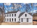 Stunning two-story home with a modern design, a black roof and a two car garage at 3290 Ethan Dr, Marietta, GA 30062