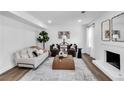 Bright living room with modern decor, wood floors, contemporary furnishings, and a cozy fireplace at 3290 Ethan Dr, Marietta, GA 30062