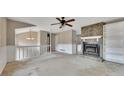 Living room featuring fireplace with stone accent wall and ceiling fan at 336 Adelene Way, Dallas, GA 30157