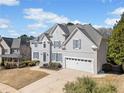 Beautiful two-story home with gray siding, manicured lawn, and a two-car garage at 1506 Brookridge Dr, Woodstock, GA 30189