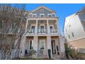 Attractive three-story home featuring a columned porch and well-maintained yard at 646 Brashy St, Woodstock, GA 30188