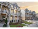 Stylish two-story home with a welcoming porch, white picket fence and manicured lawn at 646 Brashy St, Woodstock, GA 30188