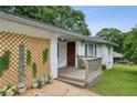 Close up of single-story home with small front porch and decorative wooden trellis on the side at 1522 Waltham Se Pl, Atlanta, GA 30316