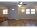 Living room with hardwood floors, ceiling fan and entryway at 10155 Twin Oaks Sw Dr, Covington, GA 30014