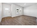 Bright living room with large windows, hardwood floors, and a welcoming atmosphere at 257 Orwell Dr, Social Circle, GA 30025