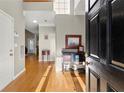 Sunlit entryway with hardwood floors and decorative console table at 2352 Kelman Pl, Dacula, GA 30019