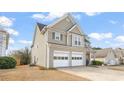 A side view of the home showing the two car garage and light colored siding at 2818 Colleton Dr, Marietta, GA 30066