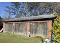 Brick garage with three large wooden doors at 505 Cedar Creek Nw Rd, Cartersville, GA 30121