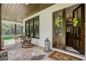 Inviting front porch with rocking chairs and a stone patio at 5341 Hill Nw Rd, Acworth, GA 30101