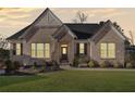 Brick home with welcoming front porch at dusk at 514 Perdue Trl, Canton, GA 30115