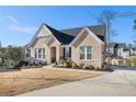 Beautiful brick home with mature landscaping, a welcoming entrance, long drive and lovely curb appeal at 514 Perdue Trl, Canton, GA 30115
