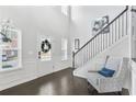 Bright foyer with hardwood floors, staircase, chair and large windows that provide plenty of natural light at 200 Cherokee Reserve Cir, Canton, GA 30115
