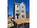 Newly constructed three-story home with light grey siding with many windows at 504 Aberdeen Meadow Ln, Acworth, GA 30102