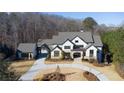 Luxury home on wooded lot with circular driveway and detached garage at 5152 Boulder Bluff Way, Suwanee, GA 30024