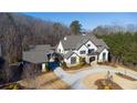 Luxury home on wooded lot with circular driveway and detached garage at 5152 Boulder Bluff Way, Suwanee, GA 30024