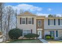 Charming two-story townhome with light siding, brick accents, and a well-manicured lawn at 4211 Wingfoot Ct, Decatur, GA 30035