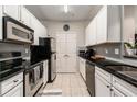 Modern kitchen with white cabinets, black countertops, and stainless steel appliances at 1250 Parkwood Se Cir # 2314, Atlanta, GA 30339