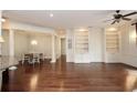 Open concept living room with dining area, hardwood floors, and custom built-in features at 351 Washington Ne Ave # 208, Marietta, GA 30060
