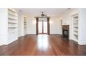 Spacious living room featuring hardwood floors, custom bookshelves, and a fireplace at 351 Washington Ne Ave # 208, Marietta, GA 30060