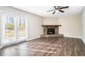 Living room with a stone fireplace and hardwood floors at 5063 S Woodbridge Trl, Stone Mountain, GA 30088